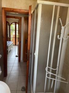 a bathroom with a glass door with a hallway at Villetta 150mt dalla Spiaggia Flumini di Quartu in Flumini di Quartu