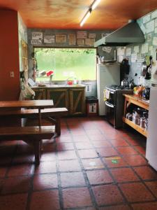 a kitchen with a table and a sink and a stove at Periko´s Youth Hostel in San Carlos de Bariloche