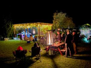 a group of people standing in a yard at night at Quirindi Sunflower Motor Inn in Quirindi