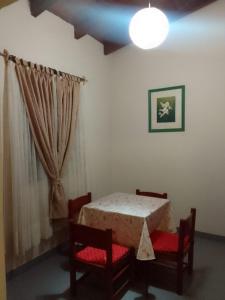 a bedroom with a table and two chairs and a window at Amancay in Payogasta