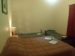 a bedroom with two beds with towels on them at Amancay in Payogasta
