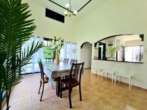 a dining room with a table and chairs at Private 4Bedroom Villa Pool,BBQ,Karaoke, Afamosa Resort in Kampong Alor Gajah