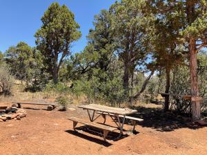 a picnic table and bench in a field with trees at Indian Canyon Ranch in Verdure +63 photos
