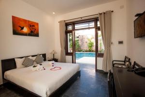 Voodi või voodid majutusasutuse Hoi An TNT Villa toas