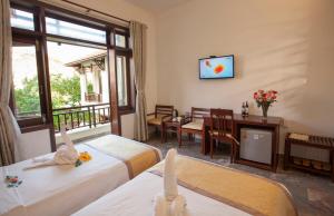 Voodi või voodid majutusasutuse Hoi An TNT Villa toas