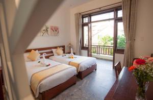 Voodi või voodid majutusasutuse Hoi An TNT Villa toas