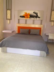 A bed or beds in a room at Villa Agung Beach Inn