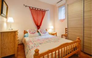 a bedroom with a large bed and a window at 1 Bedroom Cozy Apartment In Zonza in Zonza