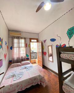 a bedroom with a bed and a window with hearts on the wall at Pousada São Marcos in Santos