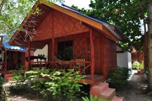 a small wooden house with a large window at Coco Garden Resort in Thongsala