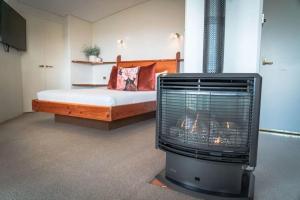 a bedroom with a bed and a fireplace in a room at Eagle View Escape in Rydal