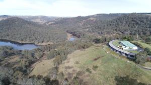 an aerial view of a house on a hill with a train at Eagle View Escape in Rydal