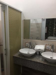a bathroom with two sinks and a mirror at Melody Homestay Quy Nhơn in Quy Nhon