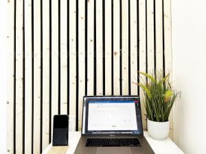 a laptop computer sitting on a desk in front of a fence at Minet Gardens House - Suite 6 in London