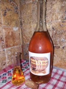 a bottle of honey next to a small glass at DOBRA RAKIJA - transit sleep in Dobra