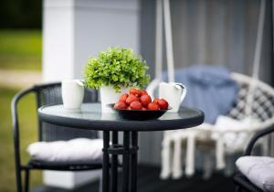 a table with a bowl of strawberries on it at OH DEER holiday house in Veismaņi