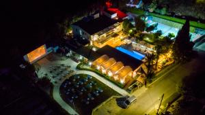 an overhead view of a building with a pool at night at Fitosinn Hotel in Paphos