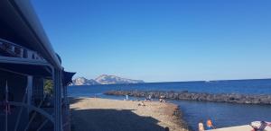 a group of people on a beach in the water at La Maison de Leo in Massa Lubrense