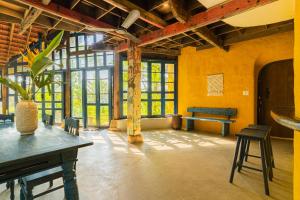 a room with a table and chairs and windows at Flow House 3BR Beachfront An Bang Beach Hoi An by Beachside Boutique Homes in An Bàn (2)