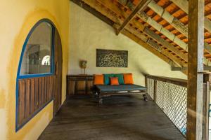 a porch with a bench in a room with an arched window at Flow House 3BR Beachfront An Bang Beach Hoi An by Beachside Boutique Homes in An Bàn (2)