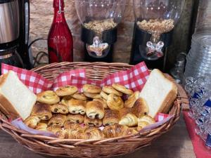 a basket of bagels and bread on a table at Ménil Bon Temps in Paris