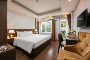 a hotel room with a bed and a chair at Hanoi Diamond King Hotel & Travel in Hanoi +71 photos