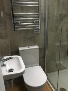 a bathroom with a toilet and a sink and a shower at 2 Agars Lane Cashel in Cashel +20 photos