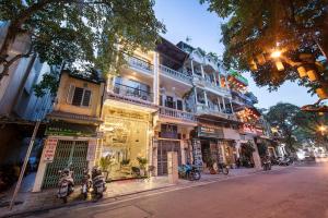 a street with motorcycles parked in front of a building at Hanoi Diamond King Hotel & Travel in Hanoi