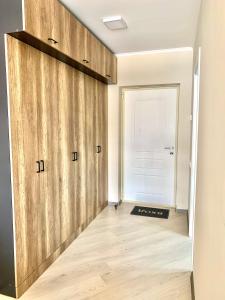 a room with wooden sliding doors in front of a door at Dream Apartment Tsaghkadzor in Tsaghkadzor
