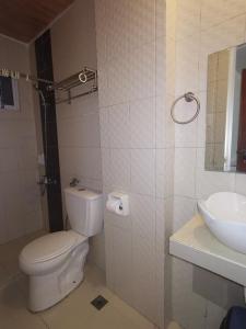 a bathroom with a toilet and a sink at Taj Guesthouse Boracay in Boracay