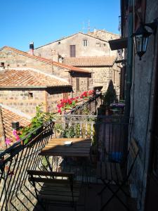 balkon ze stołem i krzesłami na budynku w obiekcie La Gioiosa w mieście Radicofani
