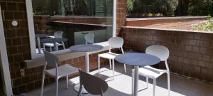 a group of tables and chairs on a patio at Puntaalarooms in Punta Ala