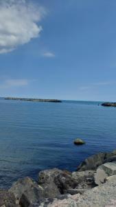 a large body of water with rocks in it at Apartament Nina in Mangalia