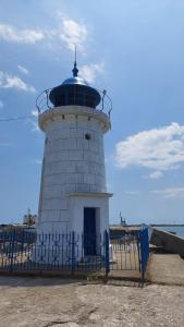 a lighthouse with a fence in front of it at Apartament Nina in Mangalia