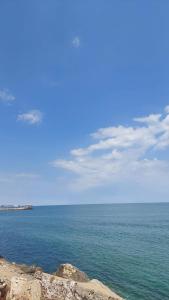 a view of the ocean from a rocky shore at Apartament Nina in Mangalia +6 photos