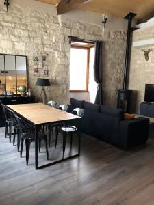 a living room with a table and a couch at Loft de charme centre de Montcuq in Montcuq