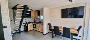 a kitchen and dining room with a table and chairs at Level780 in Koszarawa