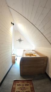 a large bed in a room with an attic at Level780 in Koszarawa