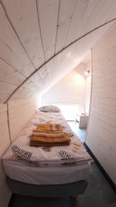 a bed in a small room with two towels on it at Level780 in Koszarawa