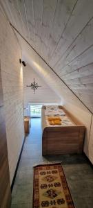 a attic bedroom with a bed in a room at Level780 in Koszarawa