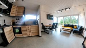 a kitchen and living room with a couch and a table at Level780 in Koszarawa