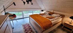 a bedroom with a bed in a small room at Level780 in Koszarawa