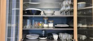 a cabinet filled with glasses and plates and dishes at Level780 in Koszarawa