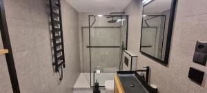 a bathroom with a shower and a sink at Level780 in Koszarawa