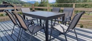 a black table and chairs on a deck at Level780 in Koszarawa