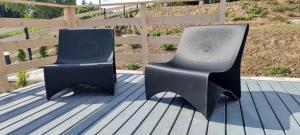 two black chairs sitting on top of a deck at Level780 in Koszarawa
