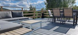 a patio with a couch and chairs on a deck at Level780 in Koszarawa