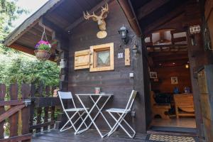 a cabin with two chairs and a table on a deck at Le Chalet du Petit Ours in Chamonix