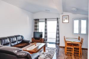 a living room with a couch and a table at Seaview Apartments Bonaca in Bar