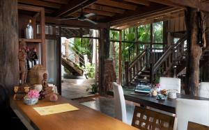 a dining room with a table with a laptop on it at The Nature in Siem Reap